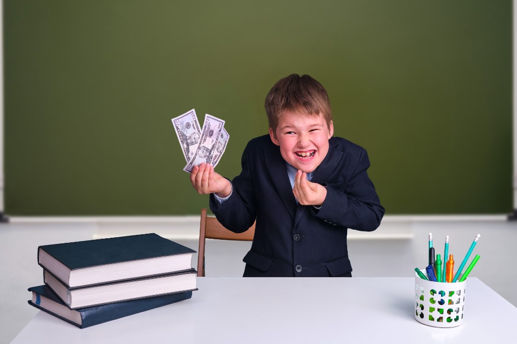 A clever boy in a jacket show paper money. A clever boy in a jacket show paper money.